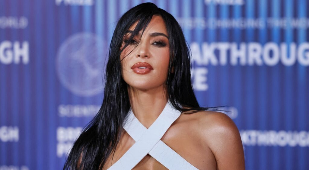Kim Kardashian posing in white outfit.