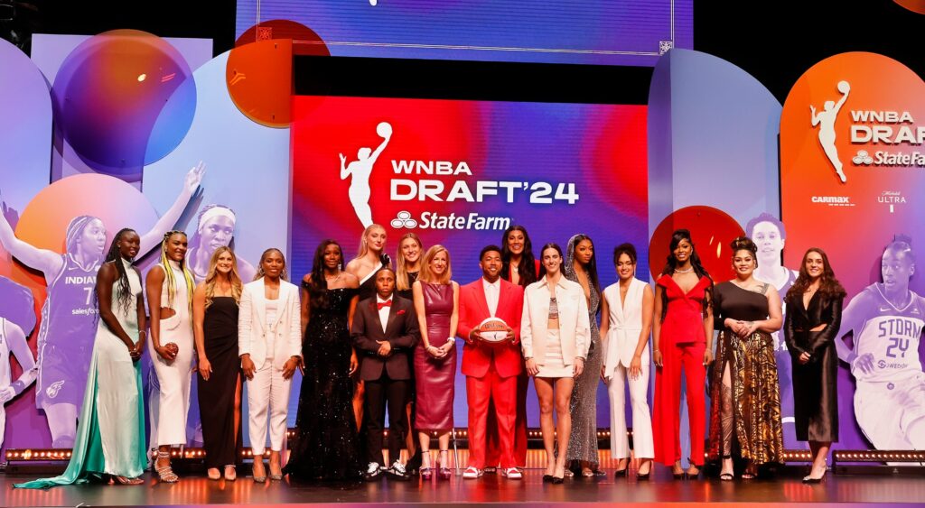 Cameron Brink and other WNBA rookies pose on stage at the draft.