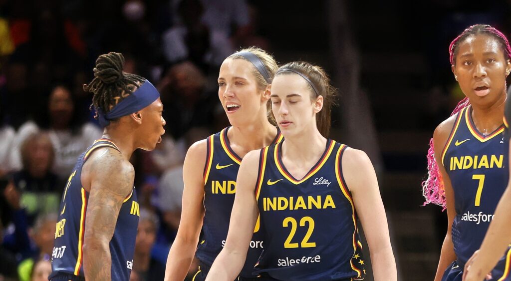 Indiana Fever players react and look on during game.