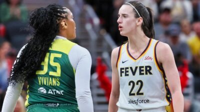 Caitlin Clark jawing with Seattle Storm player