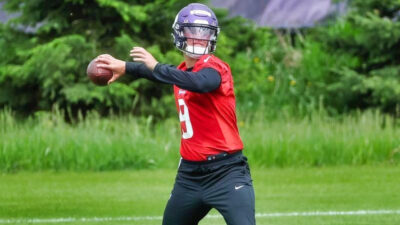 JJ McCarthy throwing a football