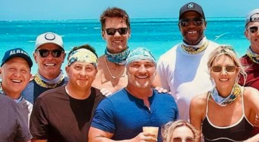 Tom Brady posing with NFL on Fox team on beach