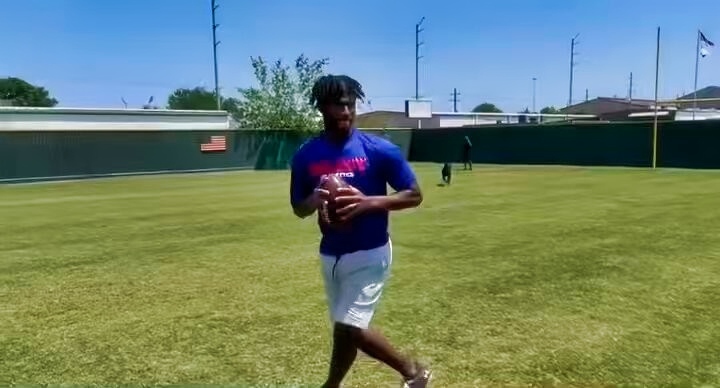 Shedeur Sanders of Colorado Buffalos holding football.