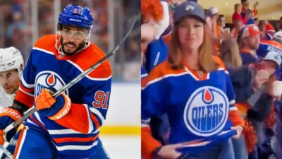 Evander Kane in uniform and female Edmonton Oilers fan in stands