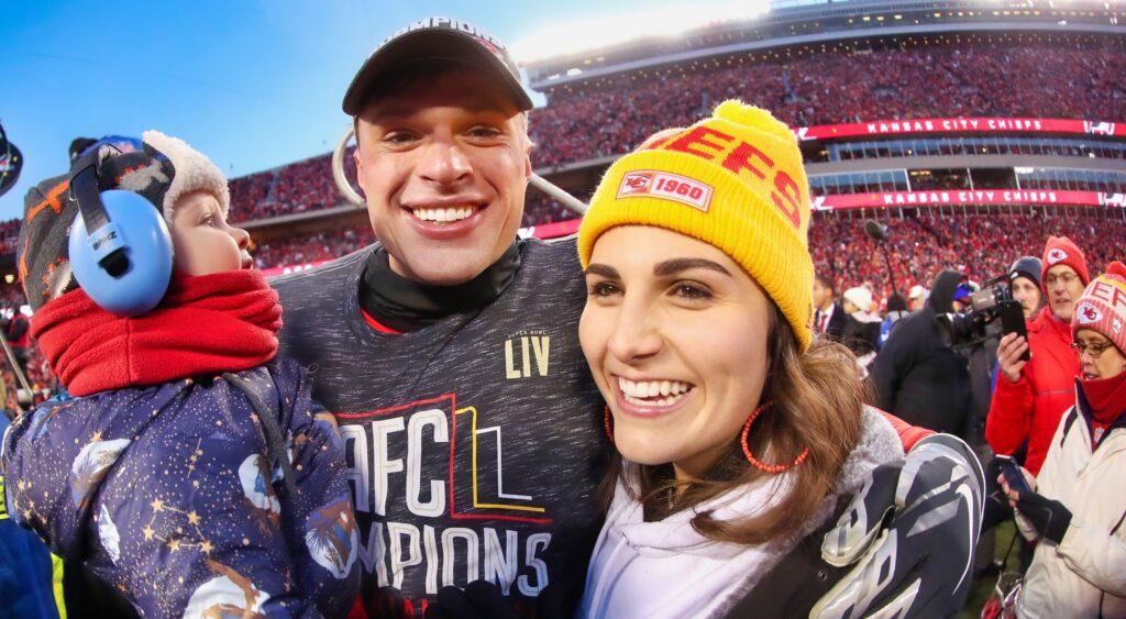 Harrison Butker and his wife Isabelle and their child celebrate after the Chiefs' AFC Championship win.