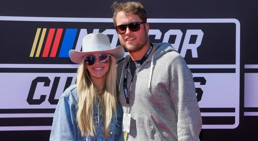 Kelly Stafford and Matt Stafford posing at NASCAR event