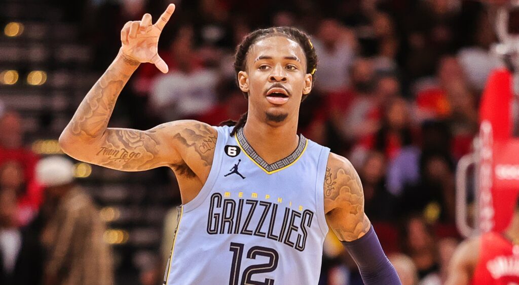 Ja Morant holds up his hand during a game.