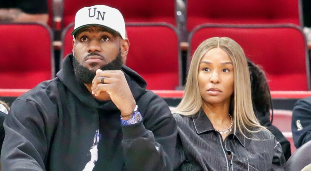 LeBron and Savannah James sitting courtside watching a game.