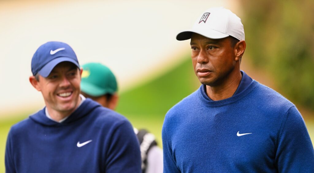 Rory McIlroy and Tiger Woods looking on at event.