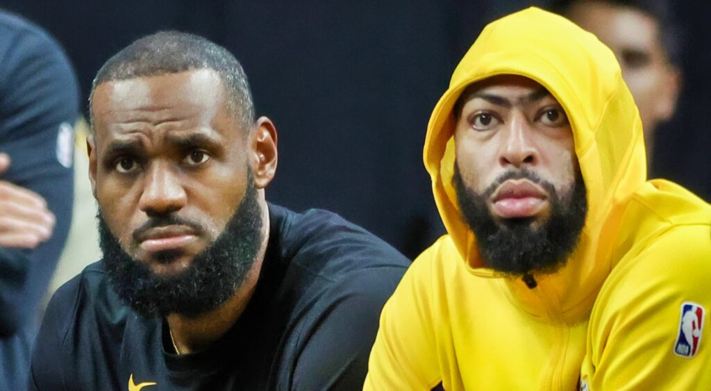 LeBron James and Antony Davis look on from the bench.