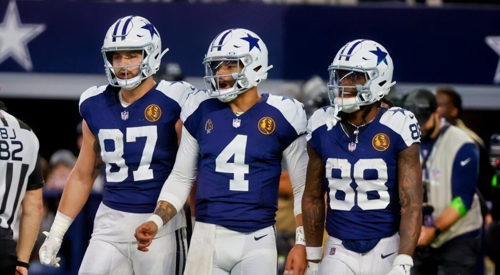 Jake Ferguson, Dak Prescott and CeeDee Lamb celebrating a play.