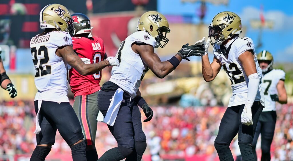 Rashid Shaheed, Juwan Johnson and Chris Olave celebrate a touchdown.