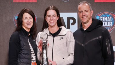 Caitlin Clark posing with parents