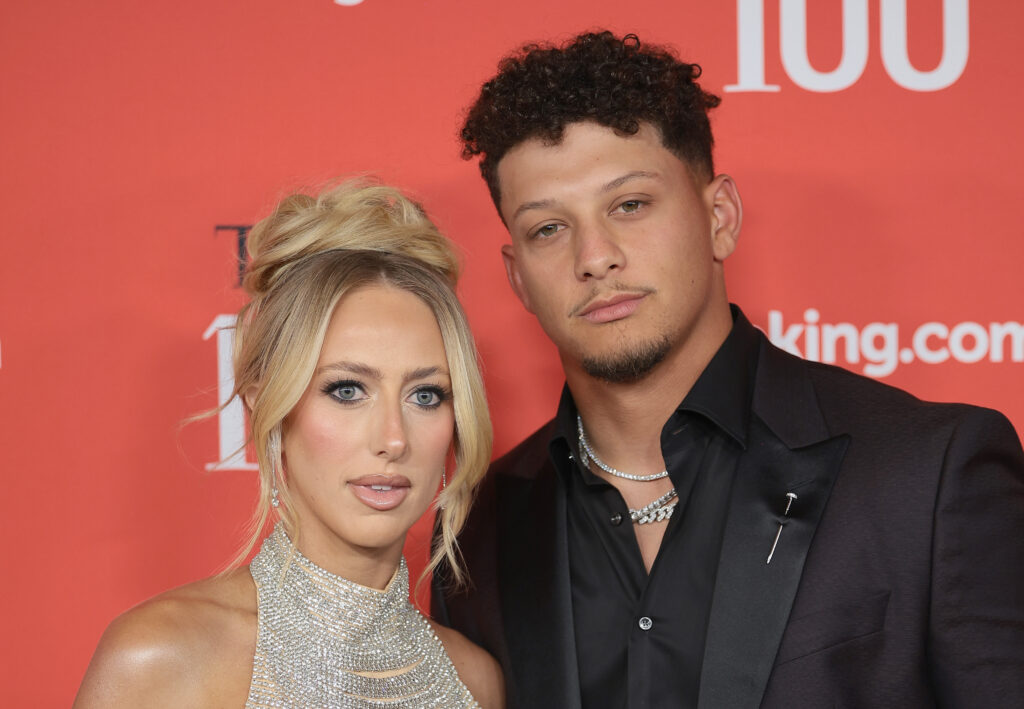 Brittany Mahomes and Patrick Mahomes pose on the red carpet.