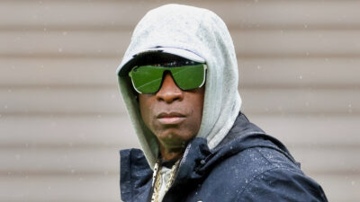 Deion Sanders in hoodie and sunglasses