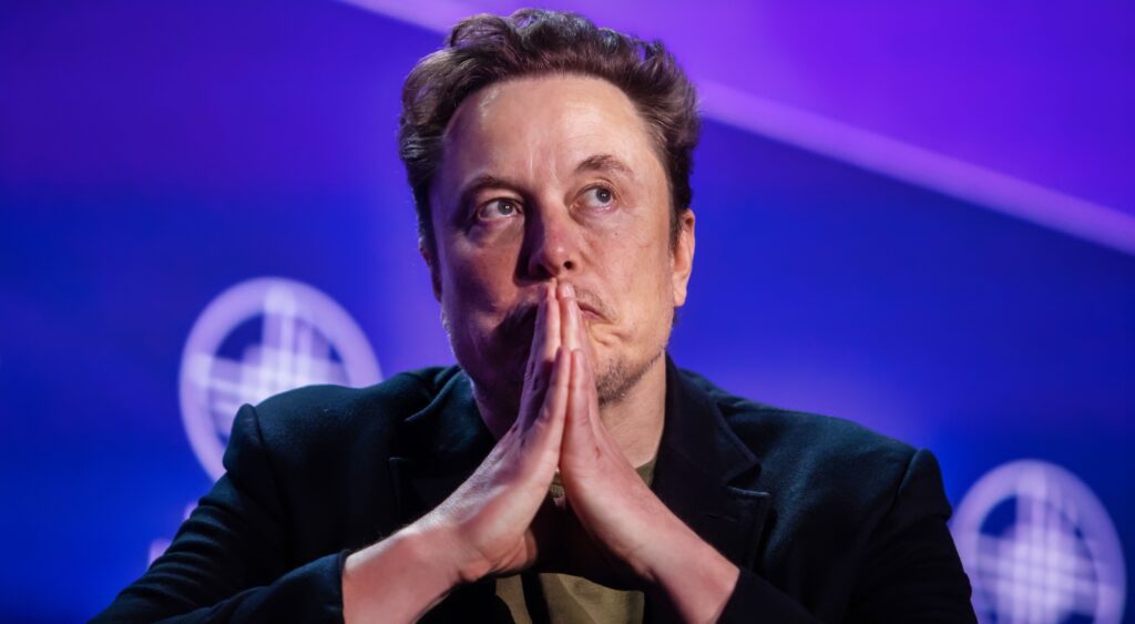 Elon Musk looks on during a talk.
