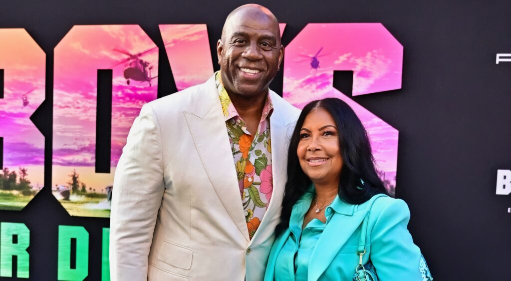 Magic Johnson and his wife Cookie Johnson pose at a movie premiere. 