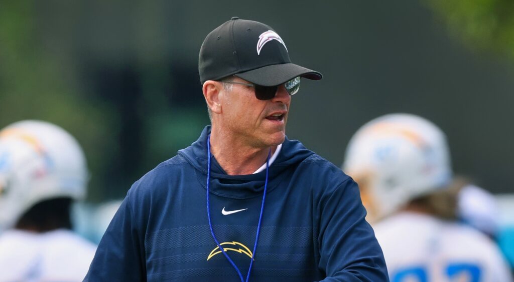 Los Angeles Chargers head coach Jim Harbaugh looking on.