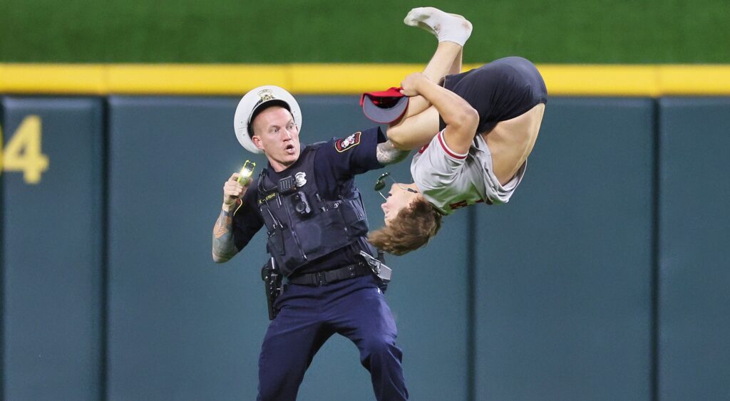 Cincinnati Reds fan doing backflip in front of cop