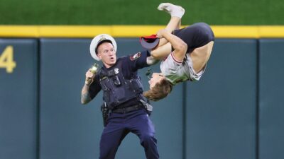 Cincinnati Reds fan doing backflip in front of cop