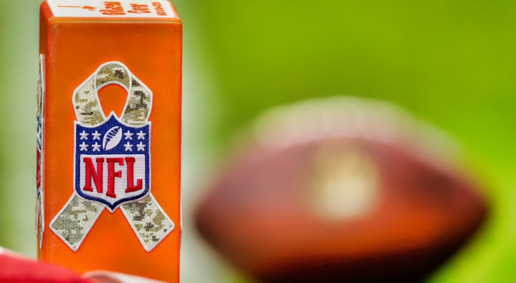 NFL logo on a goal line pylon and a ball in the background