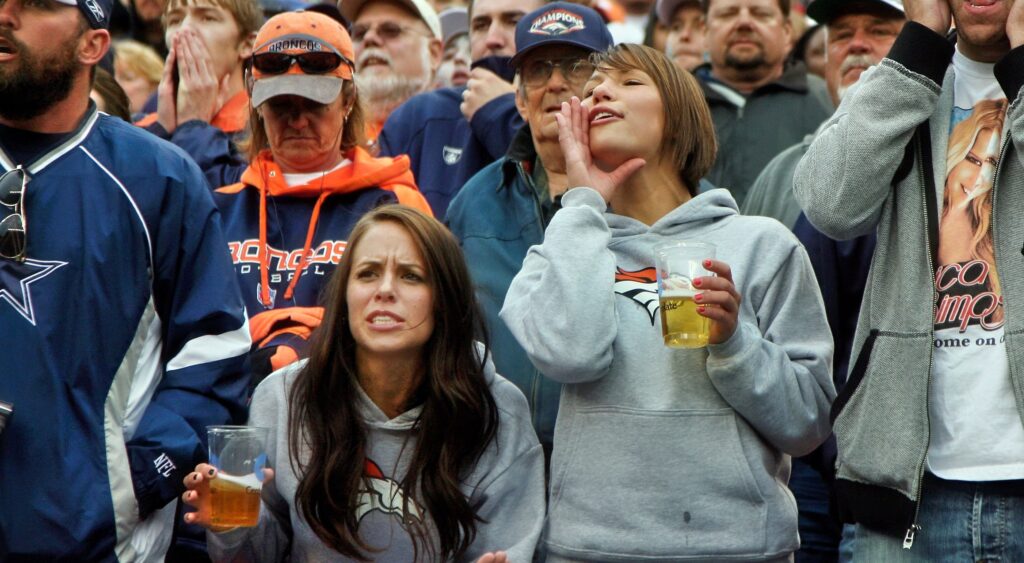 NFL fans holding beer.