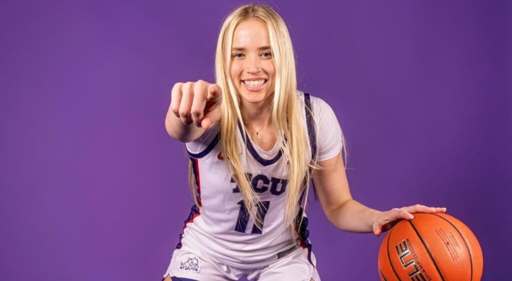 Hailey Van Lith posing in uniform with basketball