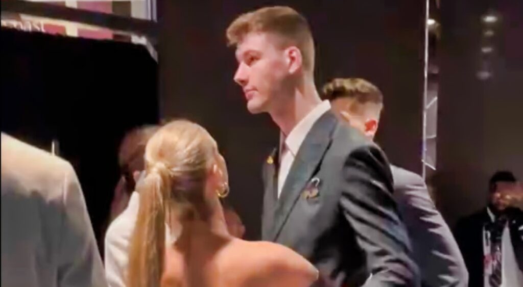 Kyle Filipowski and his girlfriend hug while leaving the NBA Draft.