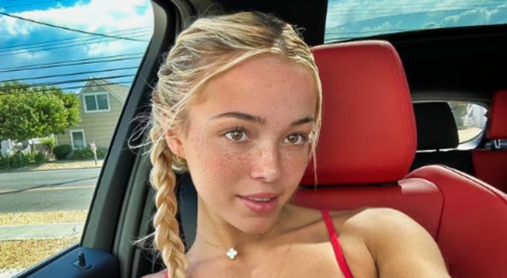 Olivia Dunne poses for a selfie in a car.