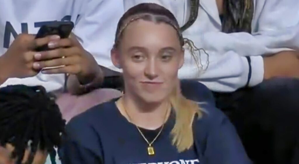 Paige Bueckers watches a WNBA game.