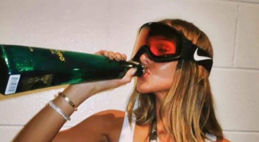 Payton Pritchard's fiancee Emma Macdonald drinks from a tequila bottle.