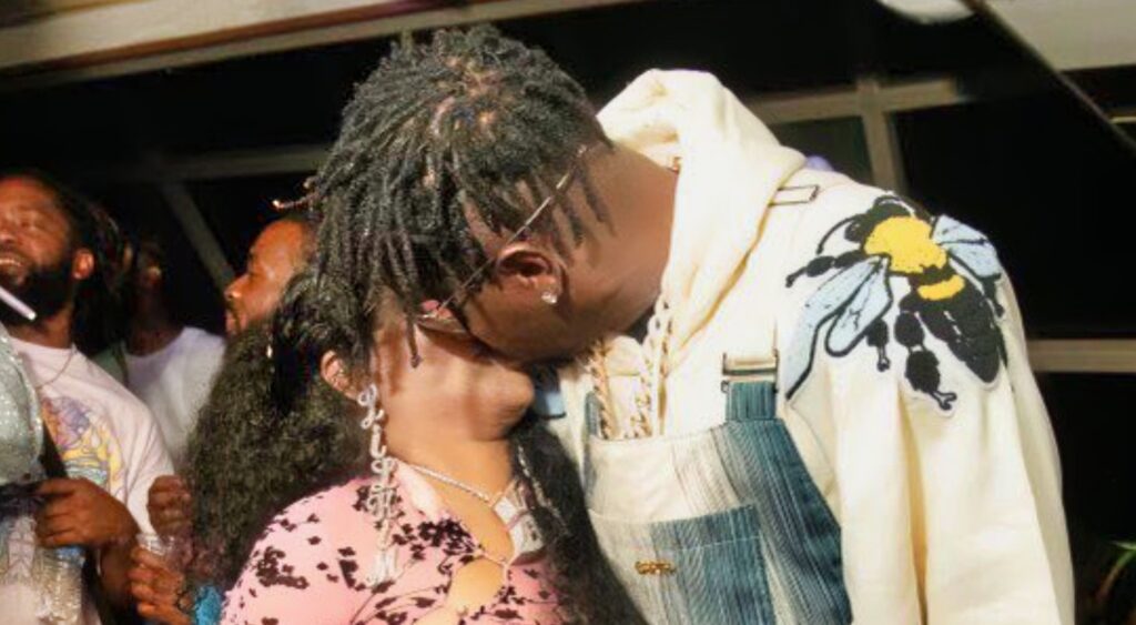 Antonio Brown and Lil' Kim kissing.