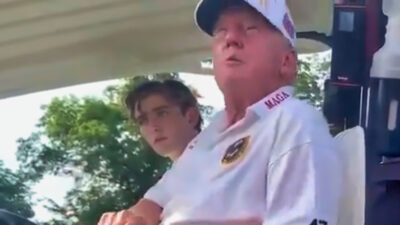 Donald Trump in golf cart with Barron Trump