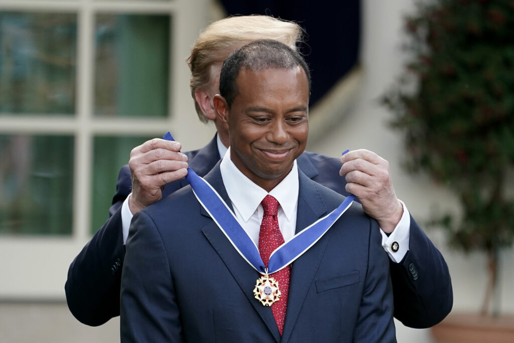 Tiger Woods receiving medal from Donald Trump