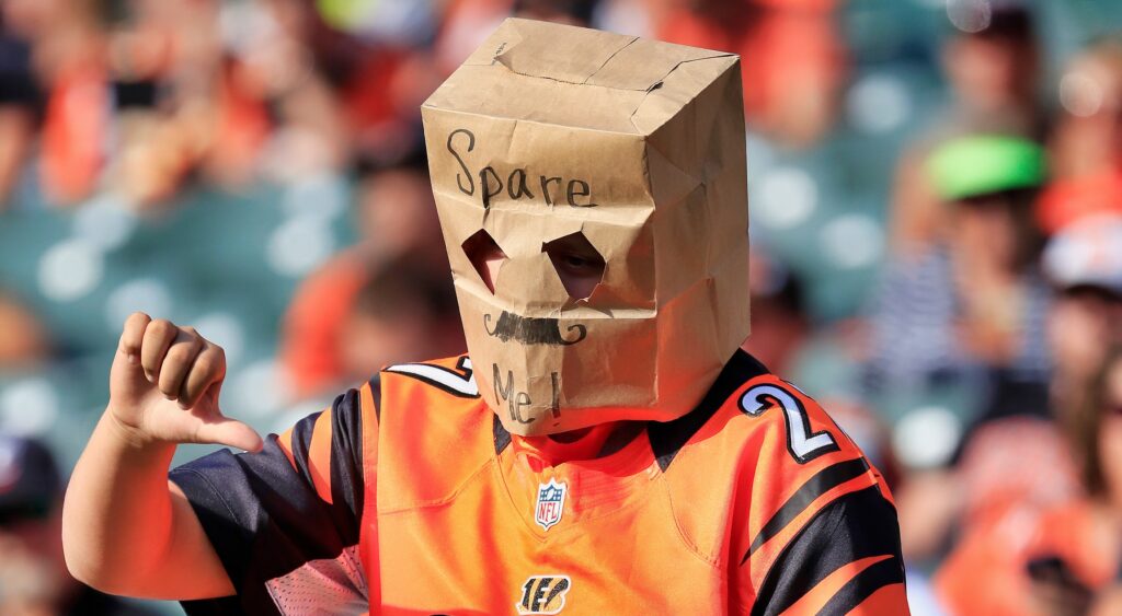 Bengals fan with a bag over his head giving thumbs down. Fans won't like the new era caps that the league introduced.