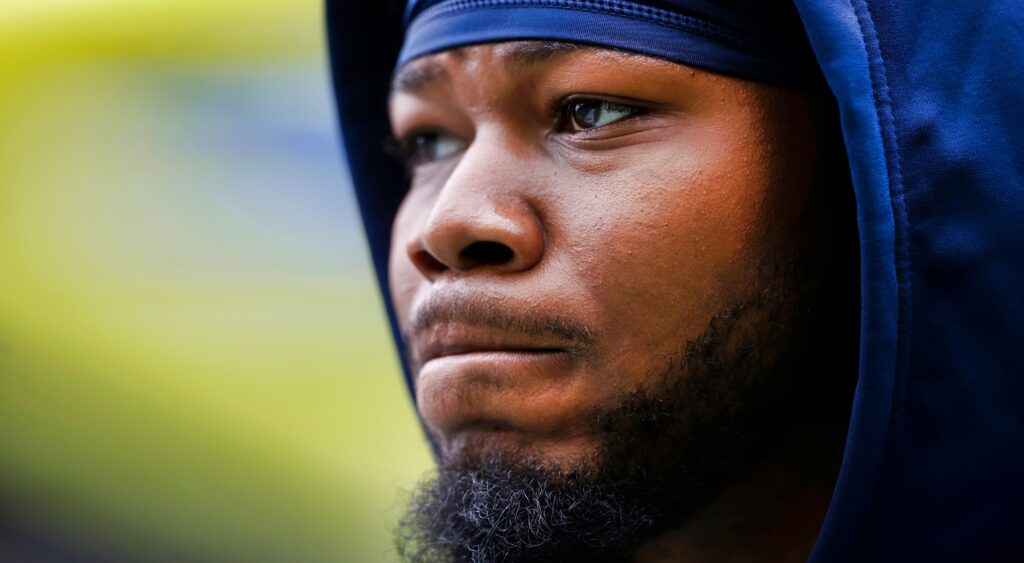 Rashaad Penny looks on.