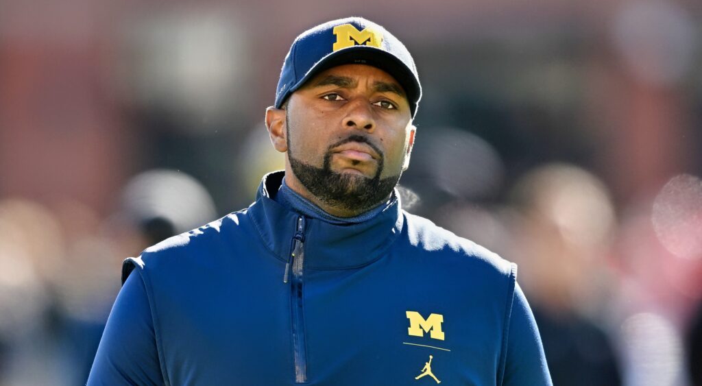 Michigan Wolverines head coach Sherrone Moore looking on.