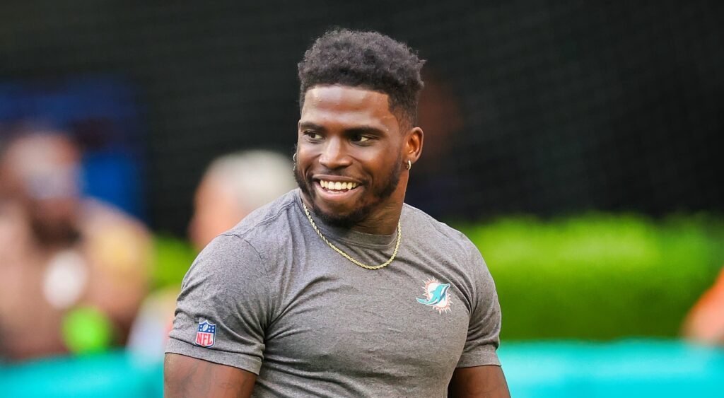 Tyreek Hill of the Miami Dolphins looking on.