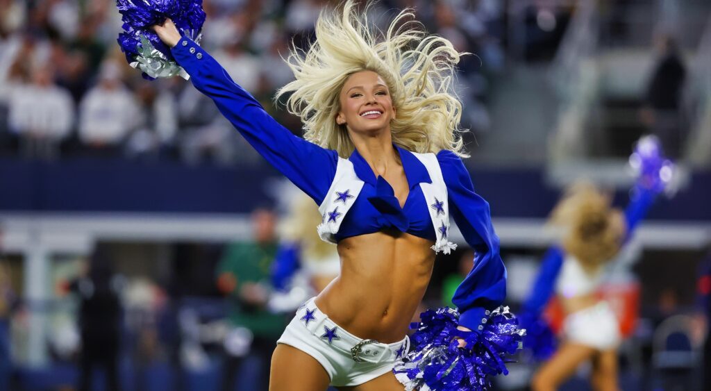 A member of the Dallas Cowboys cheerleaders performs on the field.