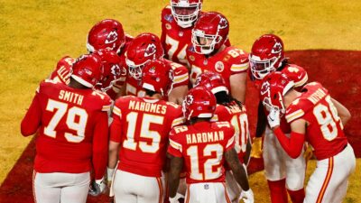 Kansas City Chiefs' players huddle that includes Travis Kelce