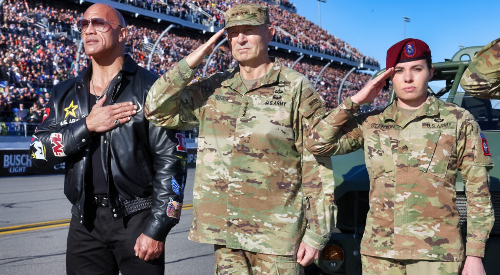 The Rock standing next to soldiers