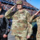 The Rock standing next to soldiers