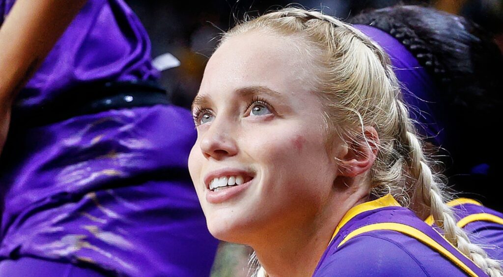 Hailey Van Lith smiling while sitting on bench