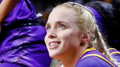 Hailey Van Lith smiling while sitting on bench