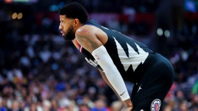 Paul George with his hands on his knees in uniform