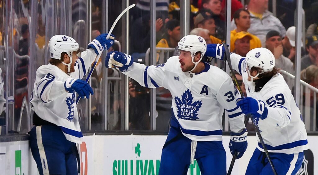Toronto Maple Leafs players celebrating a goal.