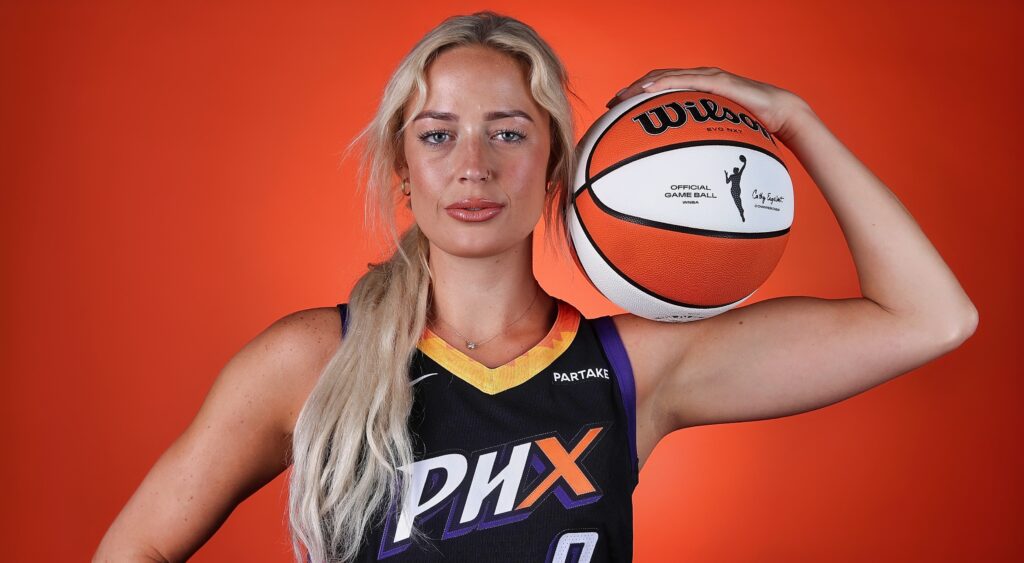 Sophie Cunningham in uniform holding a basketball.