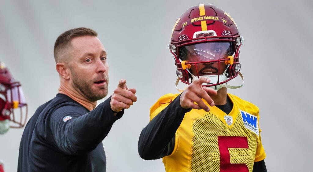 Washington Commanders' Kliff Kingsbury and Jayden Daniels pointing.