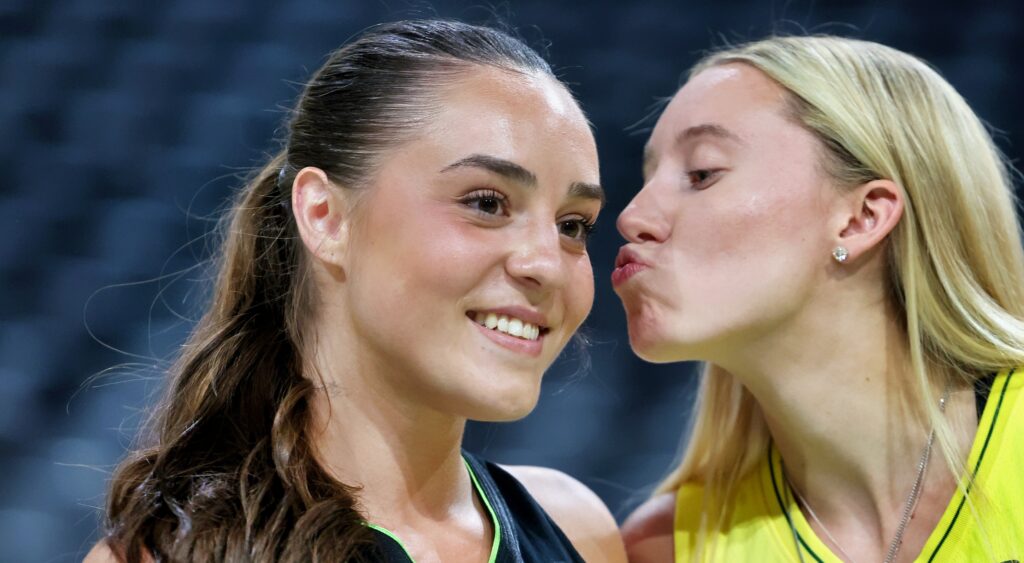 Paige Bueckers moves in to kiss Nika Muhl.