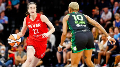 Caitlin Clark dribbling against Courtney Williams